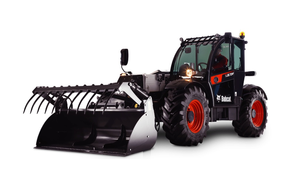 This image shows a Bobcat TL38.70HF telehandler, a powerful piece of farm machinery designed for heavy-duty tasks. It features a large grapple bucket attachment, robust tyres, and a highly protective cabin for the operator. The telehandler has a compact yet sturdy build, suitable for moving materials like hay, soil, or equipment on farms and construction sites. The machine's rugged design and versatile attachments make it an ideal choice for lifting, digging, and transporting heavy loads in agricultural settings.