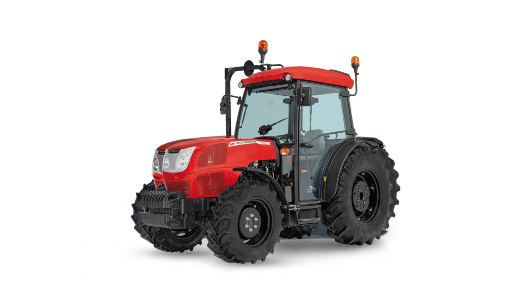 A McCormick F Series Cab Tractor is displayed in a studio setting, featuring a sleek red body and large, sturdy tyres. The fully enclosed cab design offers protection and comfort, making it ideal for versatile farm operations and tough agricultural tasks.