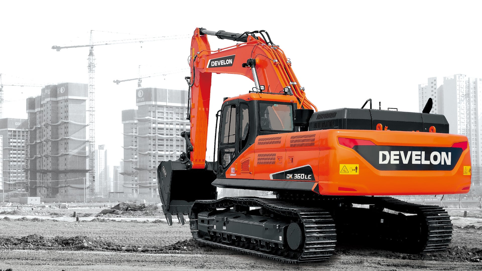 The Develon Large Excavator Range showcased against a modern urban construction backdrop, highlighting its robust performance and versatility in heavy-duty excavation and site development tasks. The bold orange design and advanced hydraulics demonstrate the power and precision expected from Develon machinery.