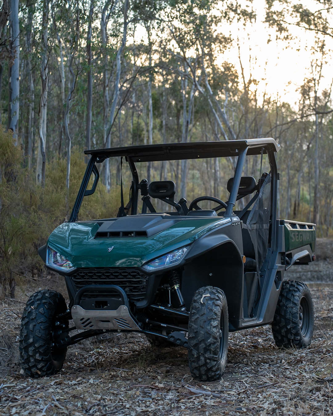 Segway UT6 Rugged EPS UTV positioned in a eucalyptus forest setting, showcasing its rugged build, off-road tyres, and practical design for bushland work and terrain navigation.