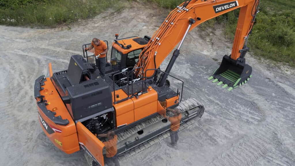 A service technician performing routine maintenance on a Develon excavator in the field, supported by Delecca's Service Department to ensure peak performance and uptime.