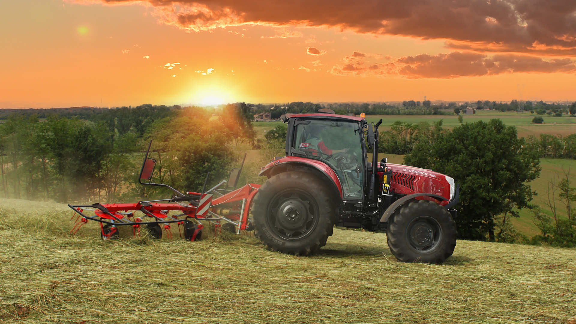 McCormick X5 Series tractor working in a hayfield at sunset — reliable performance and all-day comfort featured in Delecca’s 0.99% finance promotion.