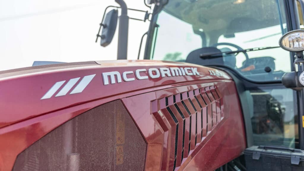 Close-up of a red McCormick X7 series tractor on a farm, showcasing power and design; promoting tractors for sale in Victoria.