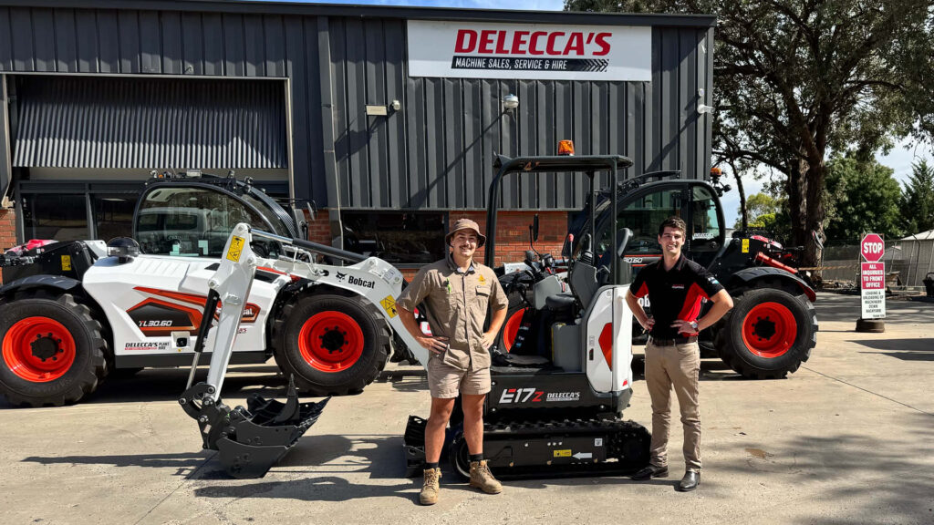 Luke from LDK Plumbing and Delecca’s team member Lachy Dunn standing beside a Bobcat E17 mini excavator at the Delecca’s dealership.