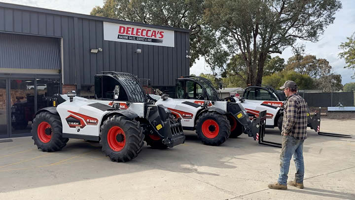 Customer evaluating range of Bobcat telehandlers at Delecca's equipment yard in regional Victoria, showing variety of models available at different price points