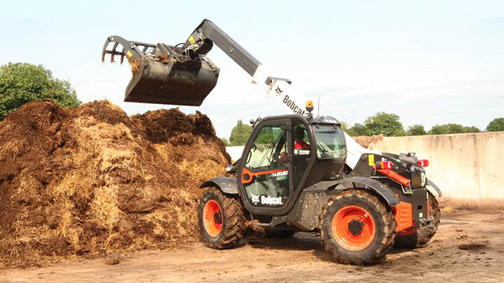 Bobcat TL30.60 agricultural telehandler with grapple bucket handling compost and farm waste