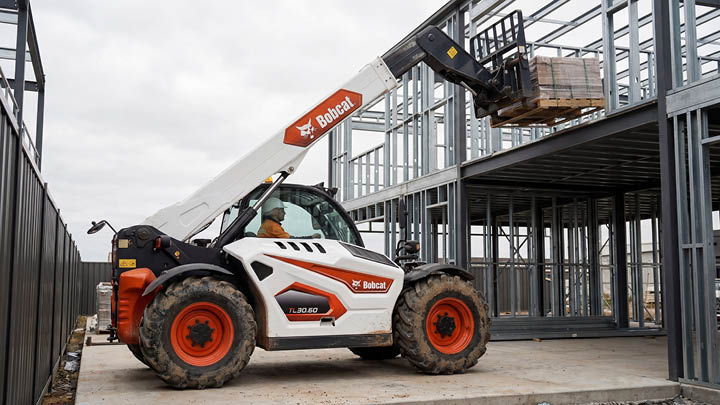 Bobcat TL30.60 construction telehandler placing materials into a steel frame structure on a commercial building site in central Victoria