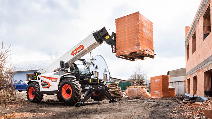 Bobcat telehandler hire for construction - lifting bricks at height on residential building site