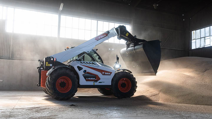 Bobcat telehandler hire fleet - grain handling with bucket attachment in farm shed
