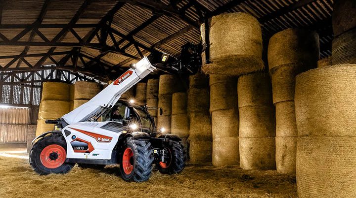 Bobcat telehandler hire for agriculture - stacking hay bales in farm shed Bendigo